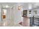 Inviting living space with modern lighting, brick fireplace, and seamless flooring transition to the bathroom at 5419 E 113Th Ave, Thornton, CO 80233