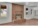 Charming living room with a brick fireplace and plenty of natural light at 5419 E 113Th Ave, Thornton, CO 80233