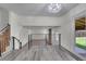 Open living space featuring iron railings and gray wood floors leading to the backyard at 5419 E 113Th Ave, Thornton, CO 80233
