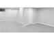 Unfinished basement with grey carpet, offering ample storage space at 7154 S Hudson Cir, Centennial, CO 80122