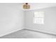 Bright bedroom with grey carpet and large window, ready for your personal touch at 7154 S Hudson Cir, Centennial, CO 80122