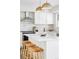 Kitchen island with white quartz countertop and three wood stools at 7154 S Hudson Cir, Centennial, CO 80122