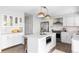 White kitchen with stainless steel appliances and an eat-in island at 7154 S Hudson Cir, Centennial, CO 80122