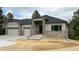 Inviting single-story residence featuring a stone facade, gray siding, and a neatly landscaped front at 6152 Powell Rd, Parker, CO 80134