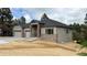 Charming single-story home with stone accents, gray siding, and a well-manicured front yard at 6152 Powell Rd, Parker, CO 80134