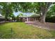 Large backyard with brick patio and mature trees at 2957 S York St, Denver, CO 80210