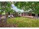 Large backyard with brick patio and mature trees at 2957 S York St, Denver, CO 80210