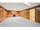 Finished basement with wood paneled walls, built in shelving, and fireplace at 2957 S York St, Denver, CO 80210
