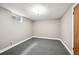 Neutral finished basement with neutral carpet tiles and access to utilities at 2957 S York St, Denver, CO 80210