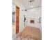 White tiled roll in shower with bronze fixtures and a sliding barn door at 2957 S York St, Denver, CO 80210