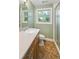 Bathroom featuring an oval mirror above a wood vanity, a toilet, and glass shower at 2957 S York St, Denver, CO 80210