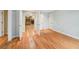 Bedroom featuring hardwood floors and an ensuite living room with built-in shelves at 2957 S York St, Denver, CO 80210