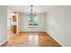 Dining room with hardwood floors, neutral paint, chandelier and window view to outside at 2957 S York St, Denver, CO 80210