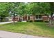 Charming single-story home with a well-maintained lawn, mature trees, and a brick exterior at 2957 S York St, Denver, CO 80210