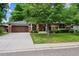 Charming exterior view of home with lush front lawn, mature tree, and a two-car garage at 2957 S York St, Denver, CO 80210