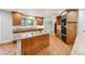 Spacious kitchen featuring stainless appliances, granite counters, and island cooktop at 2957 S York St, Denver, CO 80210