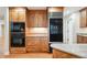 Well-equipped kitchen with custom wood cabinetry, granite counters, and stainless appliances at 2957 S York St, Denver, CO 80210