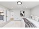 Bright bedroom with white walls, plush carpet, and a doorway that leads to an ensuite bathroom at 2040 W 45Th Ave, Denver, CO 80211