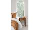 Cozy bedroom features a comfortable bed, bedside table, and natural light from the window at 2040 W 45Th Ave, Denver, CO 80211