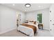 Comfortable bedroom with neutral decor, a bedside table, and an attached bathroom at 2040 W 45Th Ave, Denver, CO 80211