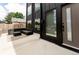 Modern home with black exterior, large windows, and comfortable patio seating area at 2040 W 45Th Ave, Denver, CO 80211