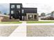 Modern home featuring a sleek black and gray exterior, landscaped front yard, and stylish architectural details at 2040 W 45Th Ave, Denver, CO 80211
