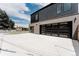 Spacious garage with a contemporary glass door and a large concrete driveway for ample parking space at 2040 W 45Th Ave, Denver, CO 80211