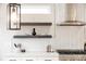 Modern kitchen featuring quartz countertops, floating shelves, and stainless steel range hood at 2040 W 45Th Ave, Denver, CO 80211