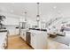 Bright kitchen with island seating, stainless steel appliances, and open layout to the living room at 2040 W 45Th Ave, Denver, CO 80211