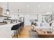 Open-concept living space features a modern kitchen with an island and adjoining seating area at 2040 W 45Th Ave, Denver, CO 80211