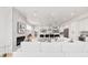 Spacious living room with fireplace flows into a modern kitchen with white cabinets and black accents at 2040 W 45Th Ave, Denver, CO 80211