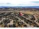 Picturesque aerial view showcasing the neighborhood with mountain views in the distance at 580 Crossing Cir, Castle Pines, CO 80108