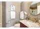 Bathroom with a dark wood vanity, granite counter, and tiled backsplash at 580 Crossing Cir, Castle Pines, CO 80108