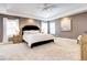 Bright and spacious bedroom featuring a tray ceiling, large windows, and plush carpeting at 580 Crossing Cir, Castle Pines, CO 80108