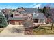 Charming two-story home featuring a three-car garage, brick accents, and covered front porch perfect for relaxing at 580 Crossing Cir, Castle Pines, CO 80108