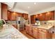 Spacious kitchen features stainless steel appliances, island cooktop and granite countertops at 580 Crossing Cir, Castle Pines, CO 80108