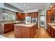 Spacious kitchen with stainless steel appliances, island cooktop and wood cabinets at 580 Crossing Cir, Castle Pines, CO 80108