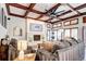 Inviting living room boasts a cozy fireplace, ceiling fan, and wood beam ceiling detail at 580 Crossing Cir, Castle Pines, CO 80108