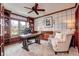 Inviting home office with custom built-ins, wood trim, and large windows providing natural light at 580 Crossing Cir, Castle Pines, CO 80108