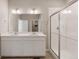 Bathroom featuring double sink vanity, quartz countertop, and glass enclosed shower at 18336 Prince Hill Cir, Parker, CO 80134