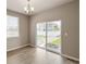 Dining room features wood-look floors, modern chandelier, and sliding glass doors to the backyard at 18336 Prince Hill Cir, Parker, CO 80134