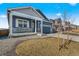 Beautiful blue home with stone accents, covered porch, and well-maintained landscaping at 18336 Prince Hill Cir, Parker, CO 80134