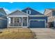 Charming single-Gathering home with blue siding, stone accents, and a two-car garage at 18336 Prince Hill Cir, Parker, CO 80134