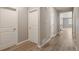 Bright hallway featuring wood-look floors, white trim, and multiple doorways at 18336 Prince Hill Cir, Parker, CO 80134