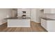Bright kitchen with white cabinets, stainless appliances, subway tile backsplash and island with sink at 18336 Prince Hill Cir, Parker, CO 80134