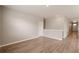 Spacious living room with wood-look floors, baseboard trim, neutral paint, and bright recessed lighting at 18336 Prince Hill Cir, Parker, CO 80134