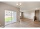 Spacious living room with wood floors, neutral walls, and sliding door access to outdoor space at 18336 Prince Hill Cir, Parker, CO 80134