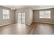 Open living area featuring wood floors, large windows, and sliding glass door to the yard at 18336 Prince Hill Cir, Parker, CO 80134