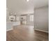 Open floorplan boasts wood-look floors and neutral paint, connecting the living, dining, and kitchen areas at 18336 Prince Hill Cir, Parker, CO 80134