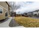 Spacious backyard with stone landscaping, a small tree and a view of other homes at 5686 Eagle River Pl, Brighton, CO 80601